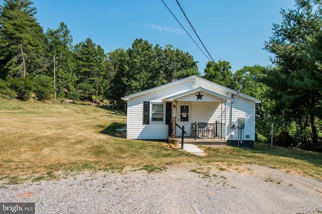 view of front of house with a front yard and a porch