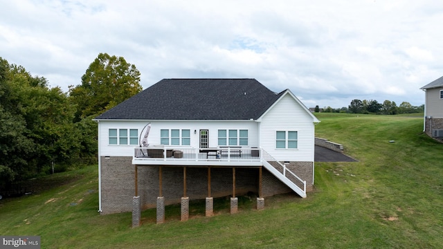 rear view of house with a lawn and a deck