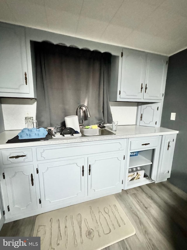 interior space featuring white cabinets and wood-type flooring