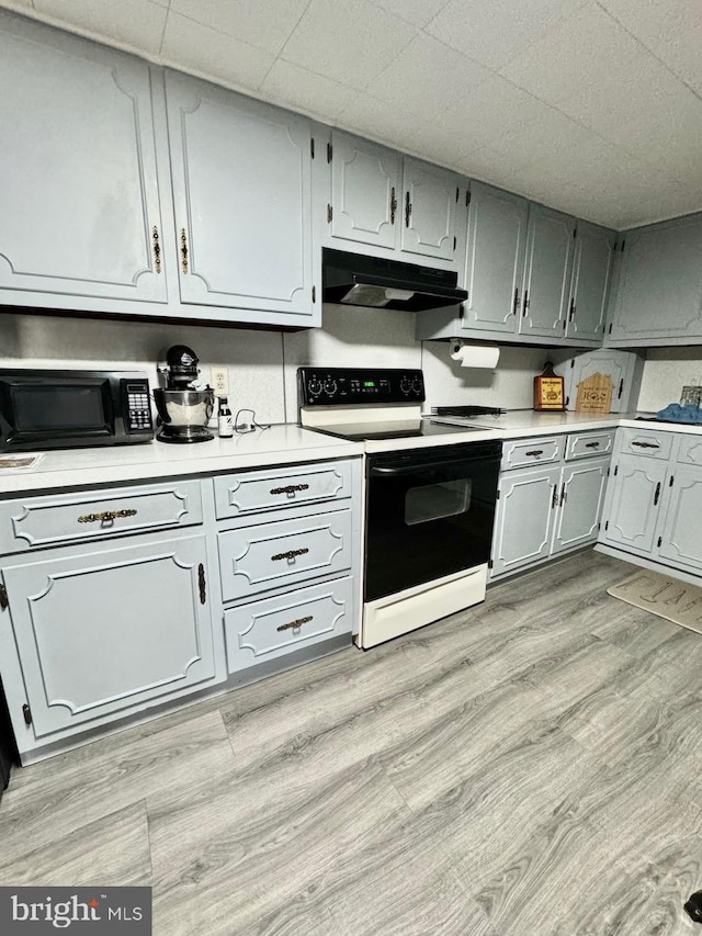 kitchen featuring light hardwood / wood-style floors and white range with electric stovetop