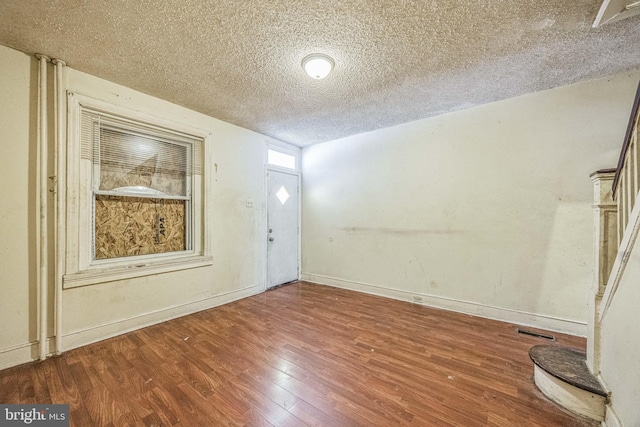 entrance foyer featuring hardwood / wood-style floors and a textured ceiling