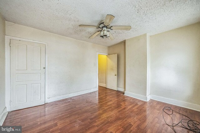 spare room with a textured ceiling, hardwood / wood-style floors, and ceiling fan