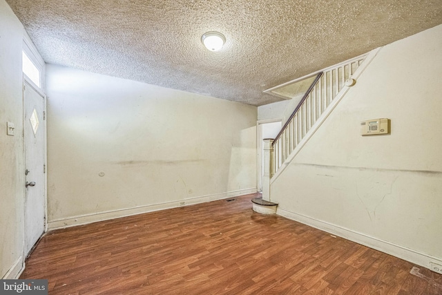 foyer with a textured ceiling and hardwood / wood-style flooring