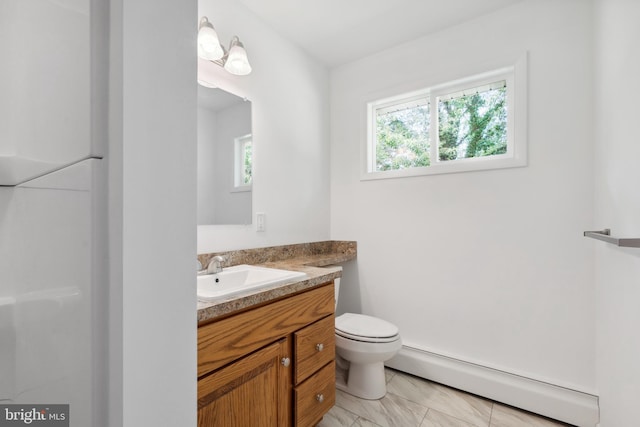 bathroom with toilet, vanity, and baseboard heating