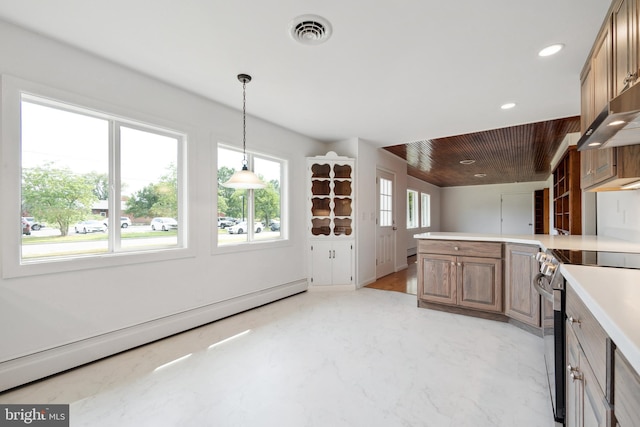 kitchen featuring a baseboard heating unit, a wealth of natural light, and stainless steel range with electric stovetop