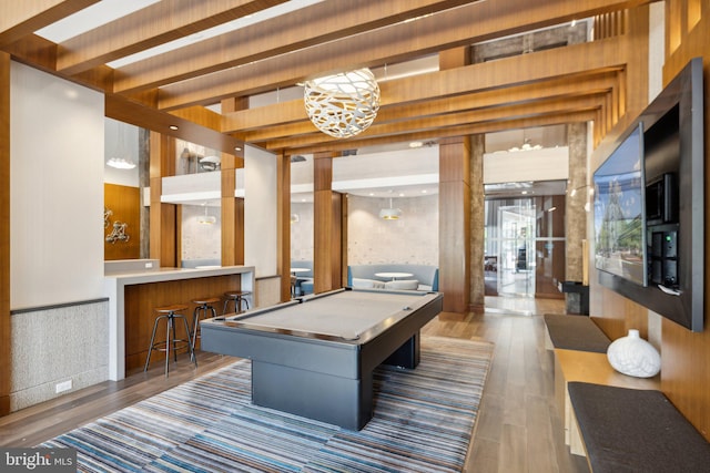 recreation room featuring dark wood-type flooring, pool table, indoor bar, and beam ceiling