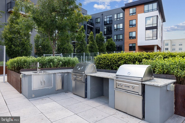 view of patio / terrace featuring sink, an outdoor kitchen, and area for grilling