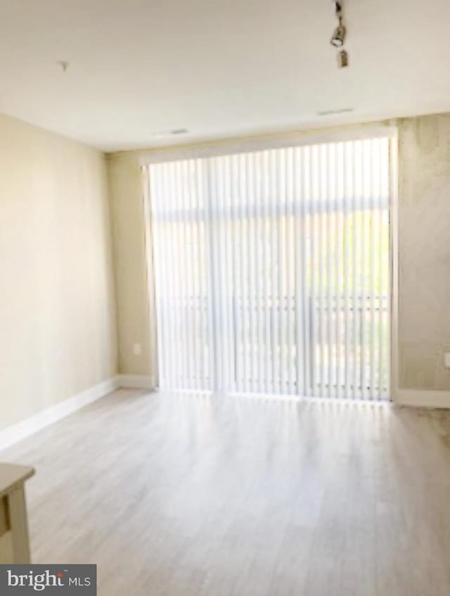 unfurnished room with hardwood / wood-style floors