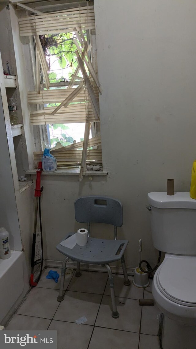 bathroom with toilet and tile patterned floors