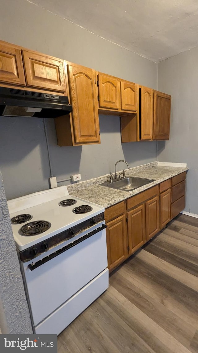 kitchen with white range with electric cooktop, dark wood-type flooring, and sink