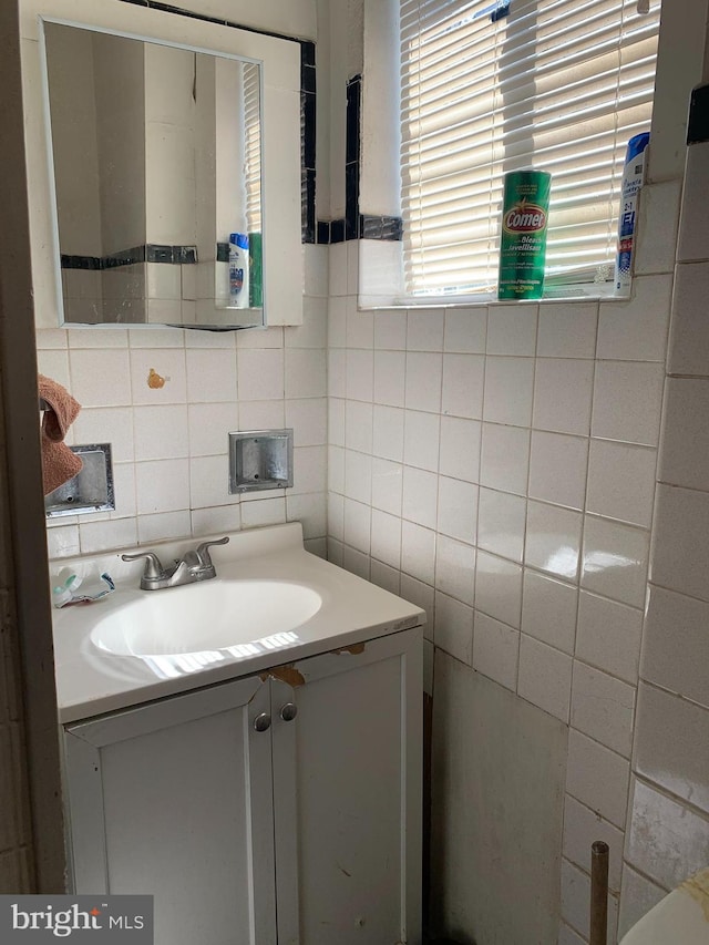 bathroom featuring tile walls and vanity