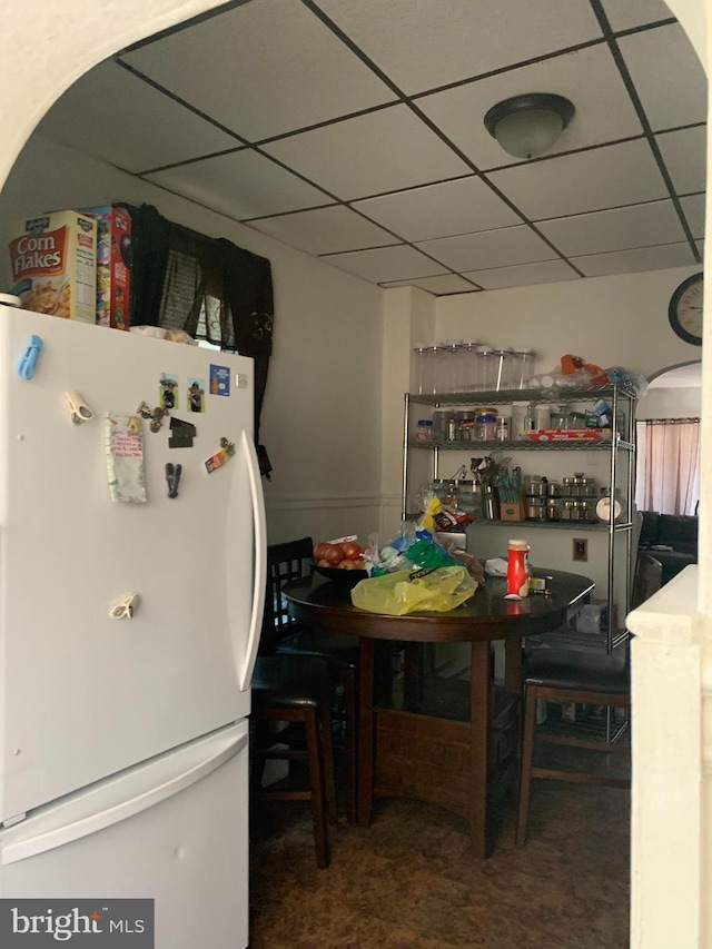 dining area with a drop ceiling