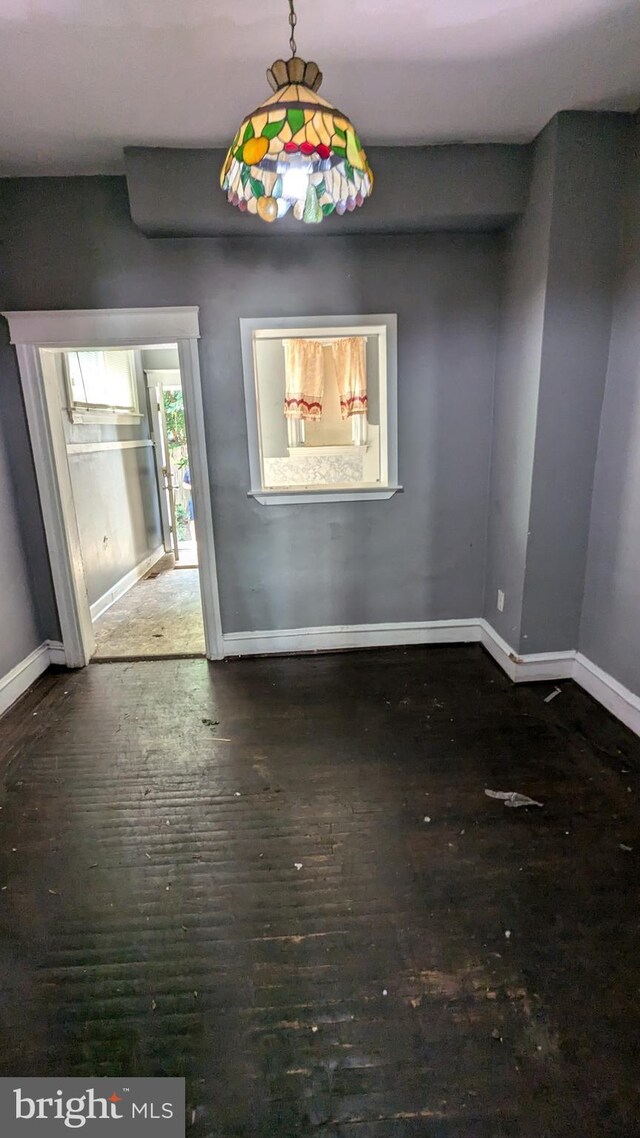 unfurnished room featuring dark wood-type flooring