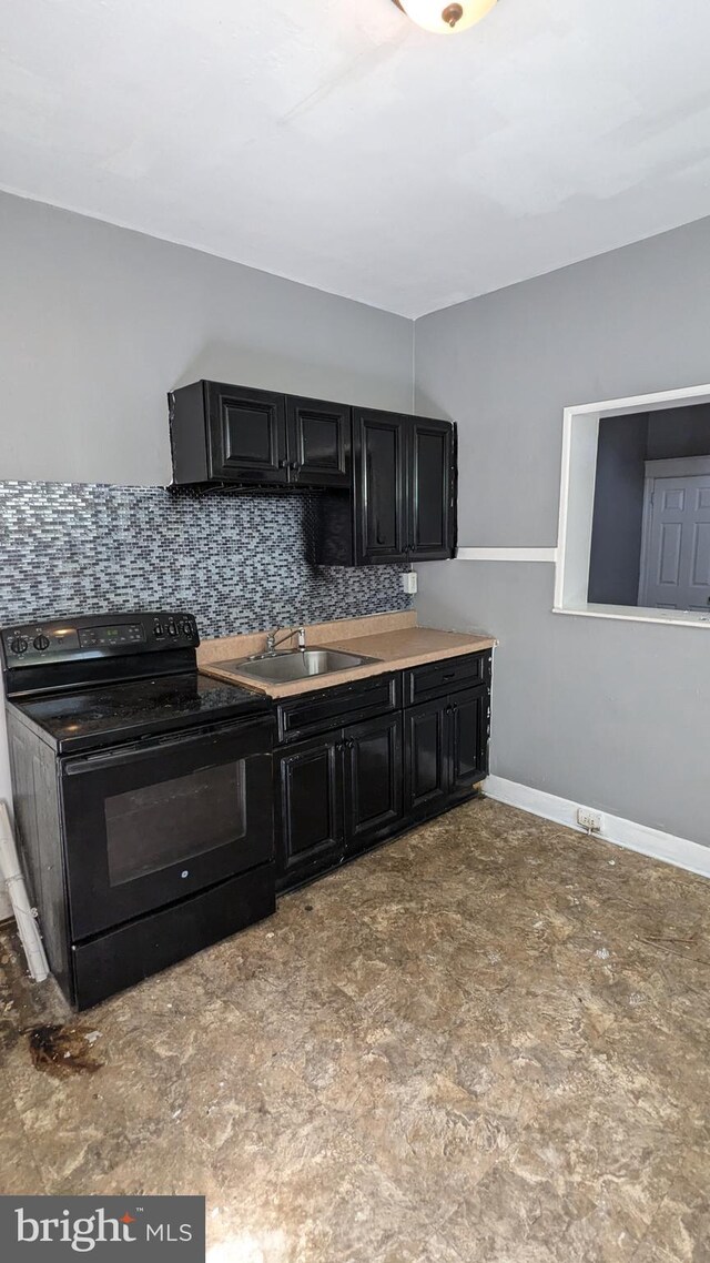 kitchen featuring black / electric stove, backsplash, and sink