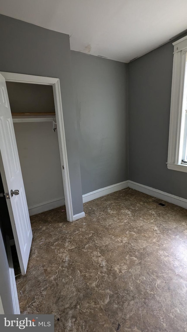 unfurnished bedroom with a closet