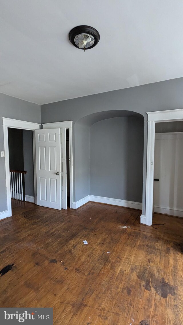 spare room with dark wood-type flooring