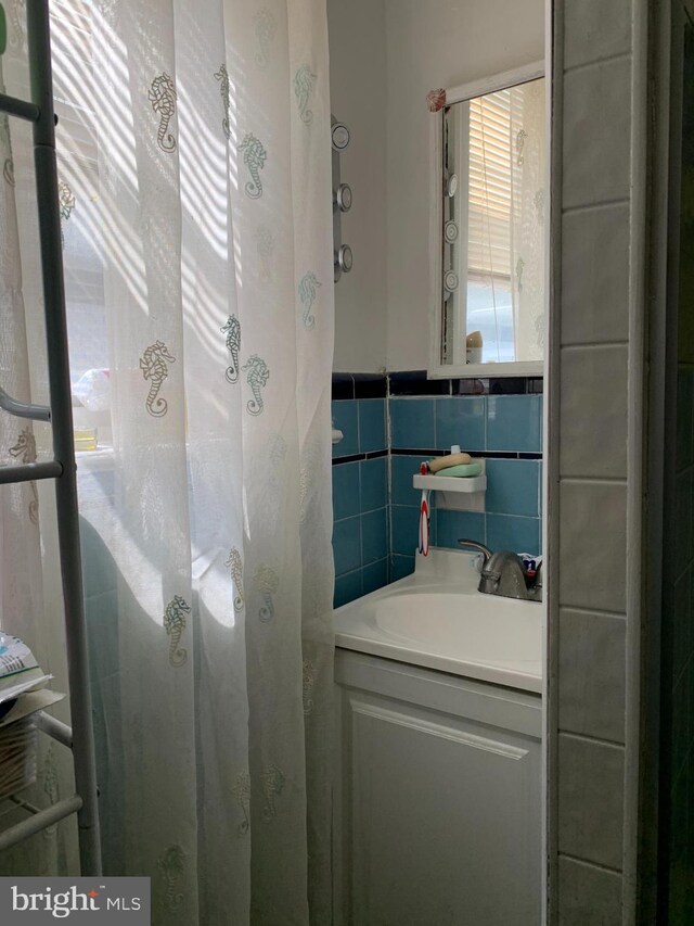 bathroom featuring tile walls and vanity