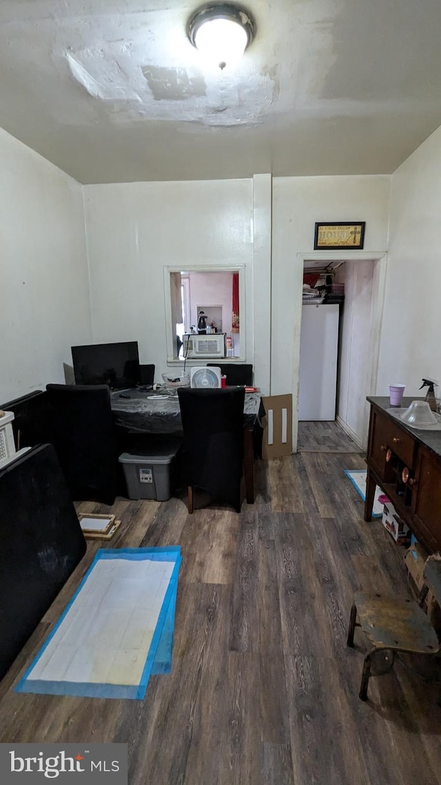 home office with dark wood-type flooring