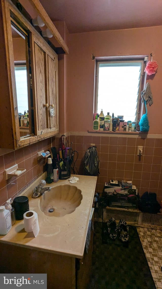 bathroom with tile walls and sink