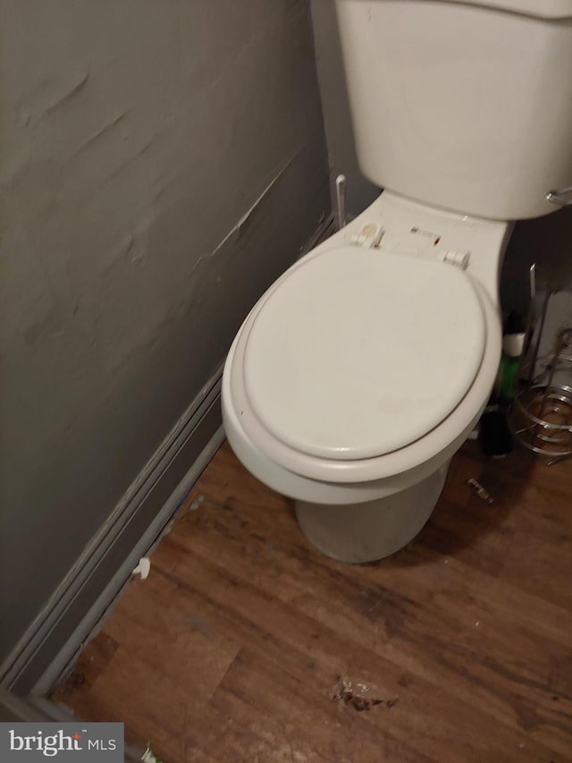 bathroom featuring wood-type flooring and toilet