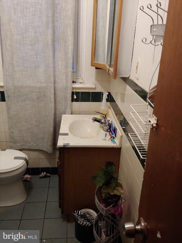 bathroom featuring backsplash, tile patterned floors, vanity, and toilet