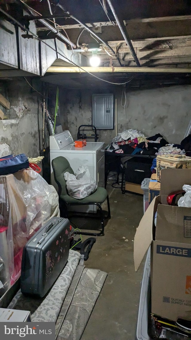 basement featuring electric panel and washing machine and dryer