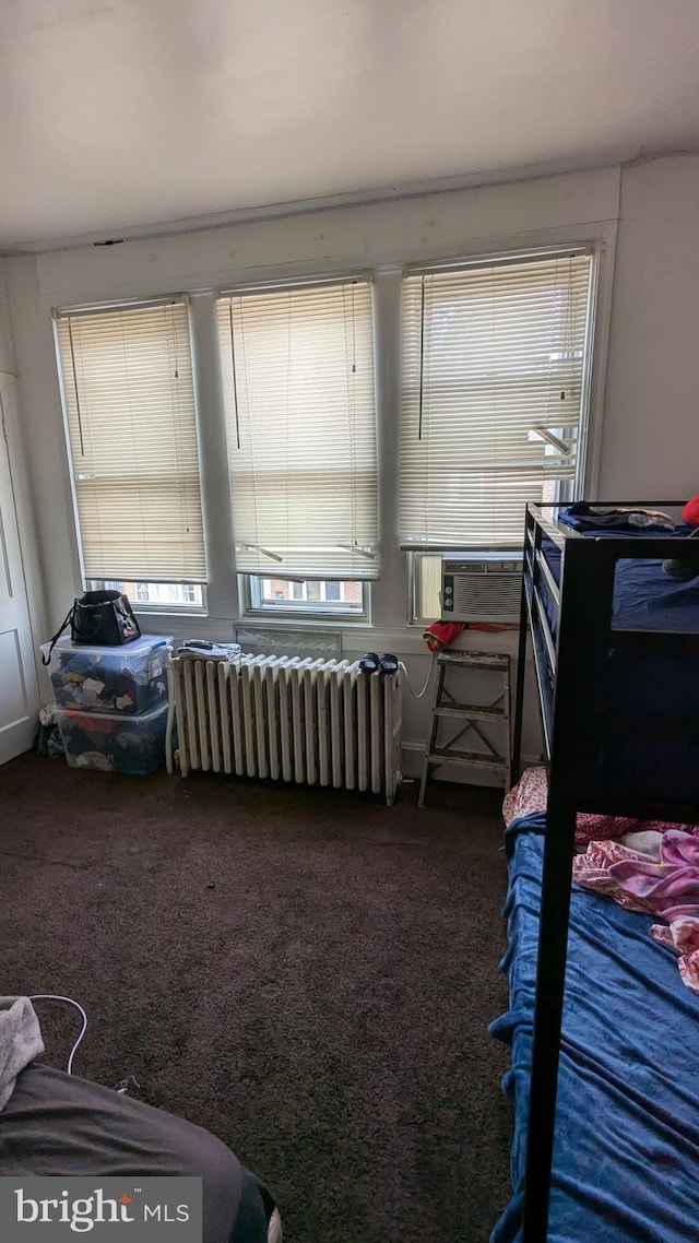 carpeted bedroom featuring radiator heating unit