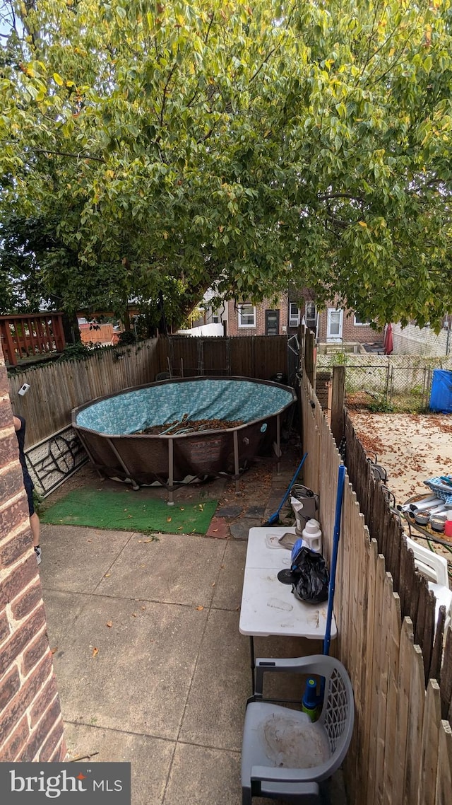 view of patio / terrace featuring a trampoline and a wooden deck