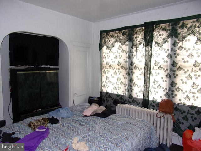 bedroom featuring a closet and radiator heating unit