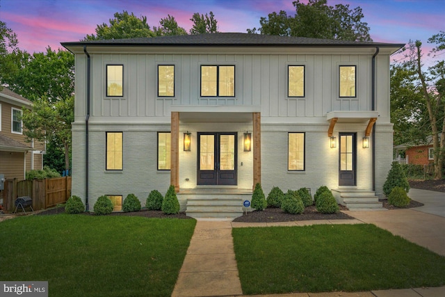 modern inspired farmhouse featuring a yard