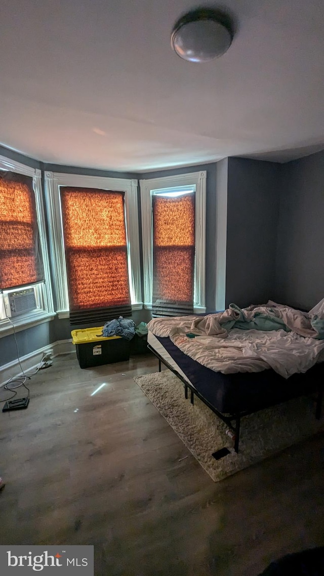 bedroom with wood-type flooring and cooling unit