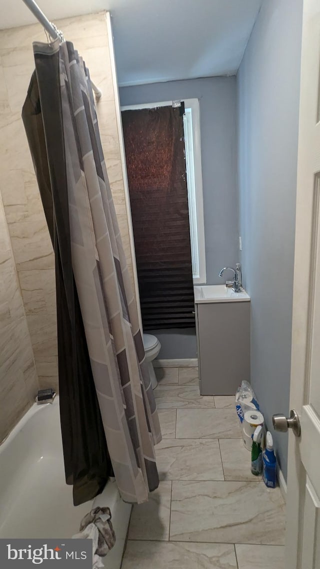 full bathroom with shower / bath combo, vanity, and toilet