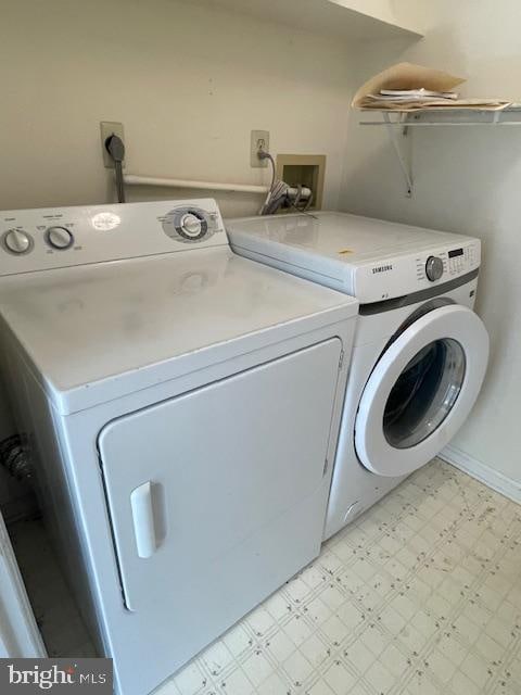 clothes washing area with washer and clothes dryer