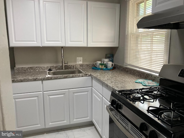 kitchen featuring white cabinets, sink, extractor fan, and stainless steel range with gas stovetop