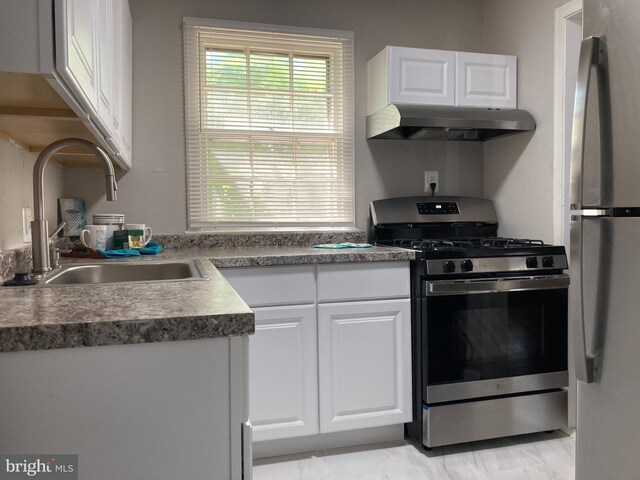 kitchen with white cabinets, appliances with stainless steel finishes, and sink