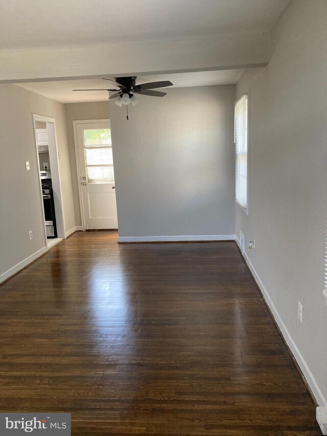 spare room with ceiling fan and dark wood-type flooring