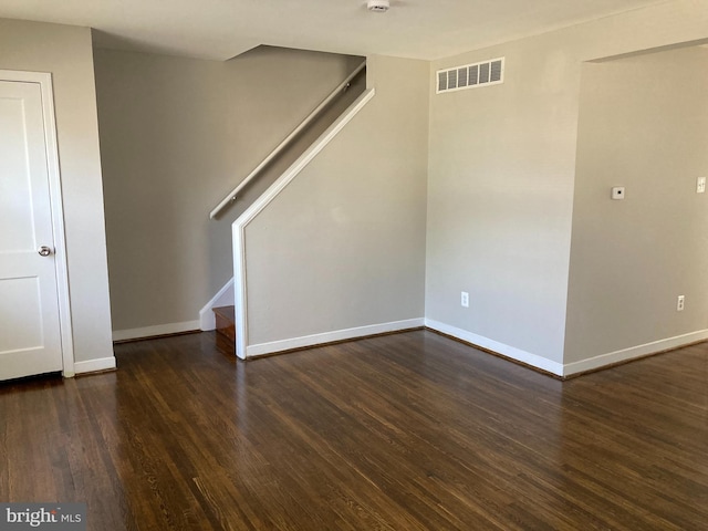 empty room featuring dark hardwood / wood-style flooring