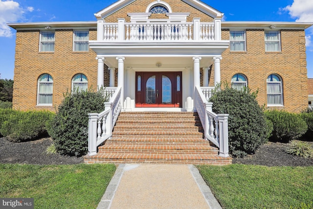 view of front of property with covered porch and a balcony