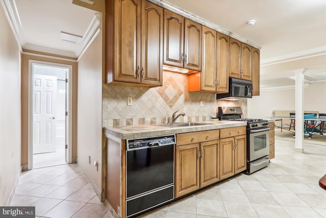 kitchen with tasteful backsplash, crown molding, sink, tile countertops, and black appliances