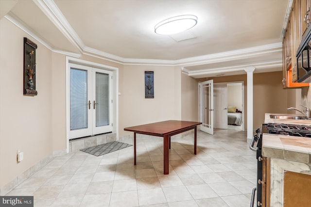 interior space with french doors, ornamental molding, and sink