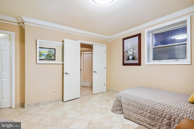 tiled bedroom featuring a closet and ornamental molding