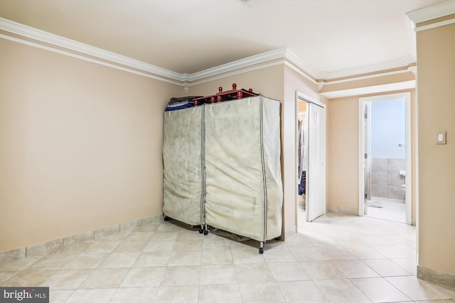 interior space with crown molding and light tile patterned floors