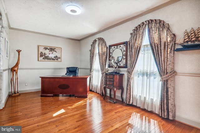 office area featuring crown molding, hardwood / wood-style flooring, and a textured ceiling