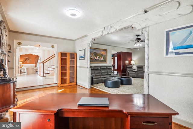 home office featuring ornamental molding, ceiling fan, and light hardwood / wood-style floors