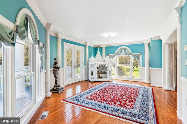 interior space featuring french doors, hardwood / wood-style flooring, and plenty of natural light