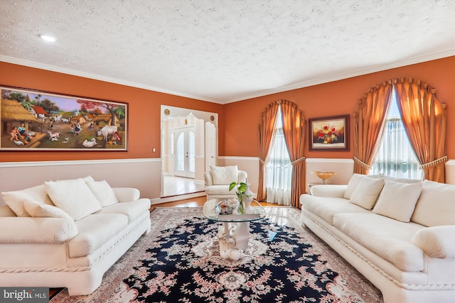 living room with ornamental molding, hardwood / wood-style floors, and a textured ceiling