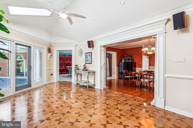 unfurnished living room with ceiling fan with notable chandelier, crown molding, parquet floors, and vaulted ceiling with skylight