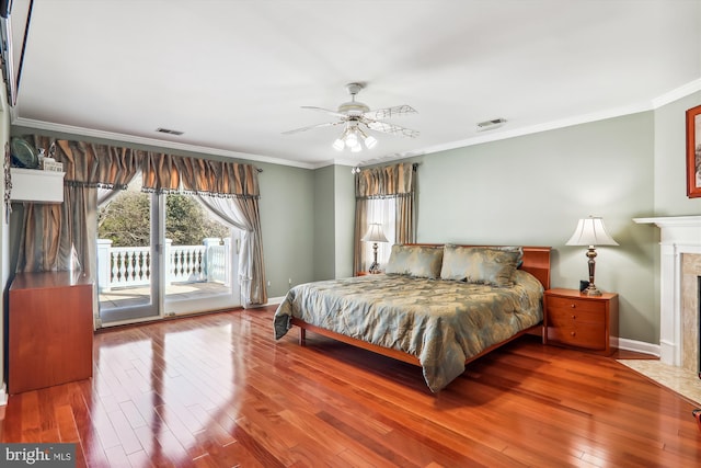 bedroom with crown molding, access to exterior, hardwood / wood-style floors, and ceiling fan