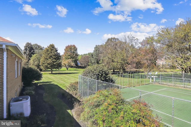 view of sport court with a yard