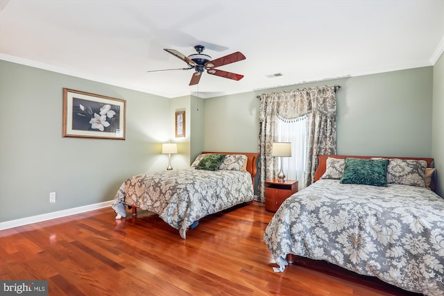 bedroom featuring wood-type flooring, ornamental molding, and ceiling fan